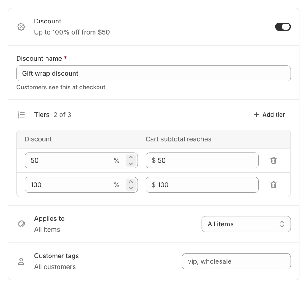 The Discount settings, turned on: the discount is named Gift wrap discount, takes 50% off the gift when the cart reaches $50, and 100% off at $100, for all items and all customers